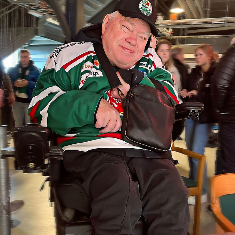 Bilden visar Tommy, på hockeymatch, han är arbetsledare för sin personliga assistans